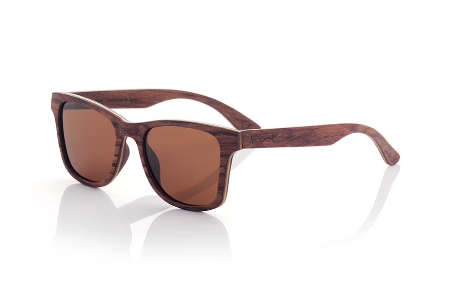 Wood eyewear of Rosewood MARIO. MARIO wooden sunglasses are a classic and timeless model that will perfectly complement any masculine look. Made entirely of laminated rosewood with a thin layer of maple interspersed, the combination of dark and light tones creates an elegant and subtle contrast. Fitting comfortably against the head, the temples are made from the same laminated wood for added durability. Classic styling and high-quality craftsmanship make these sunglasses a sophisticated and fashionable choice. Lenses available in solid shades of gray and brown provide full protection from the sun's rays. Front Measurement: 145x48mm Caliber: 52 for Wholesale & Retail | Root Sunglasses® 